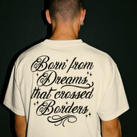 'Dreamers: Born From Dreams That Crossed Borders' Unisex T-Shirt - Ivory - Premium Cotton